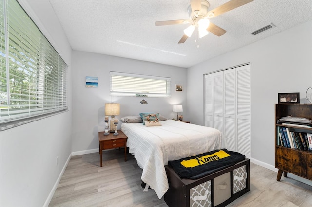 8841 SW 91st St Unit A, Ocala, FL 34481 - bedroom featuring light wood-style floors, a closet, a textured ceiling, and ceiling fan