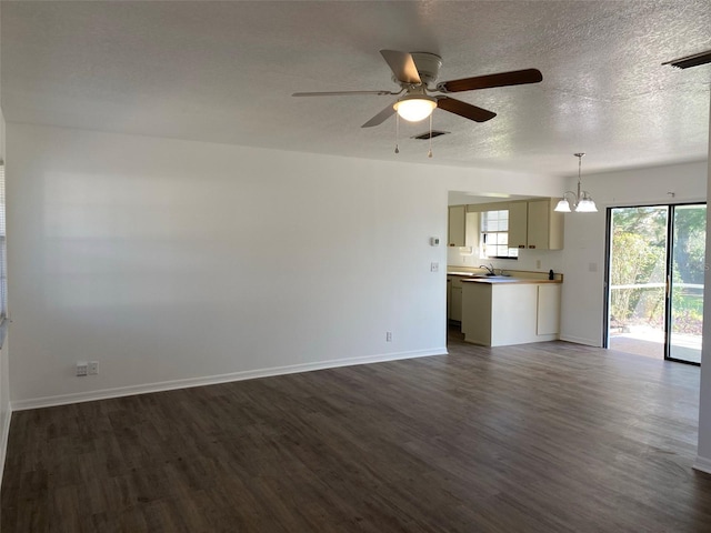 3381 NW 44th Ct, Ocala, FL 34482 - unfurnished living room with dark wood finished floors, a chandelier, ceiling fan, and a textured ceiling