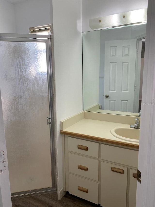 3381 NW 44th Ct, Ocala, FL 34482 - bathroom with a stall shower, wood finished floors, and vanity