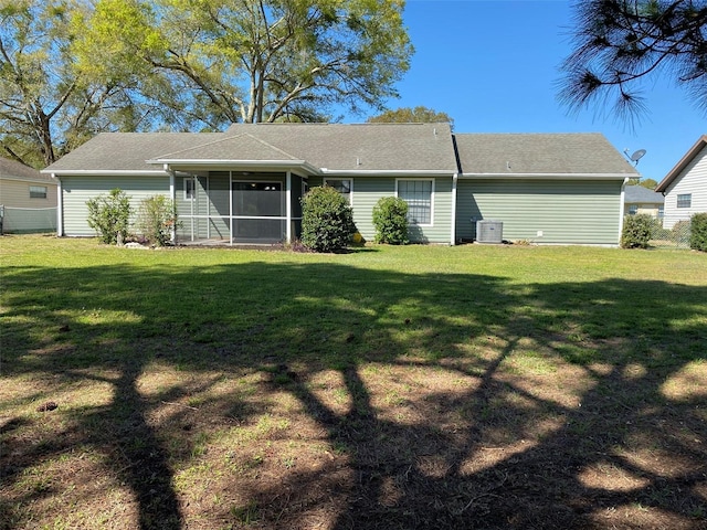 3381 NW 44th Ct, Ocala, FL 34482 - rear view of house with a sunroom, a lawn, and roof with shingles