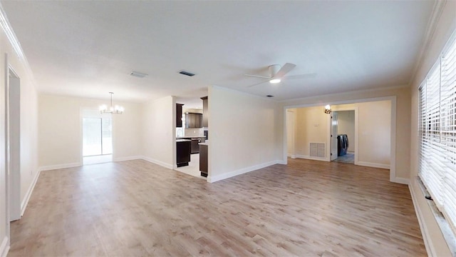 4121 SW 6th Ave, Ocala, FL 34471 - unfurnished living room featuring a chandelier, ceiling fan, light wood-type flooring, plenty of natural light, and ornamental molding