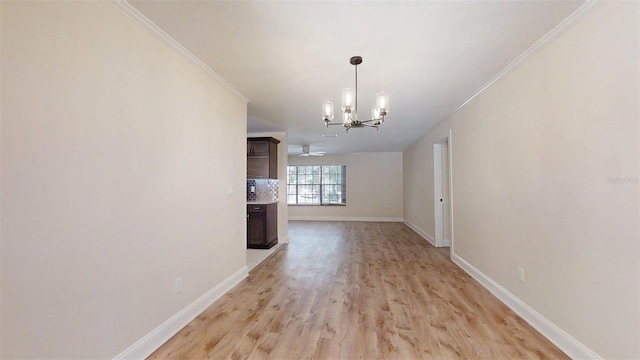 4121 SW 6th Ave, Ocala, FL 34471 - unfurnished dining area with a chandelier, crown molding, and light wood-style flooring
