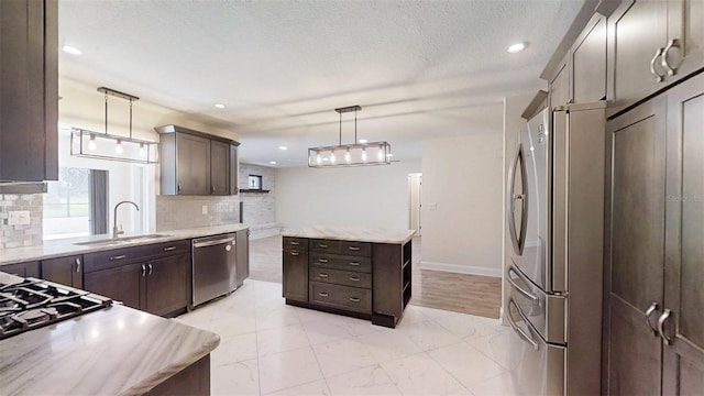 4121 SW 6th Ave, Ocala, FL 34471 - kitchen with appliances with stainless steel finishes, dark brown cabinets, decorative backsplash, hanging light fixtures, and recessed lighting