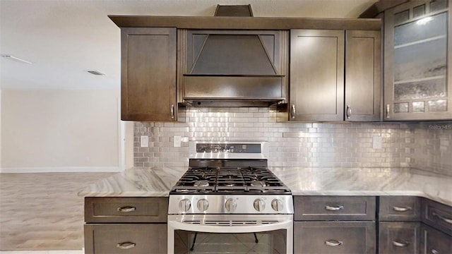 4121 SW 6th Ave, Ocala, FL 34471 - kitchen with stainless steel gas stove, custom exhaust hood, tasteful backsplash, and dark brown cabinets