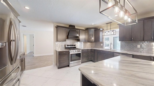4121 SW 6th Ave, Ocala, FL 34471 - kitchen with appliances with stainless steel finishes, dark brown cabinetry, light stone countertops, premium range hood, and light marble finish flooring