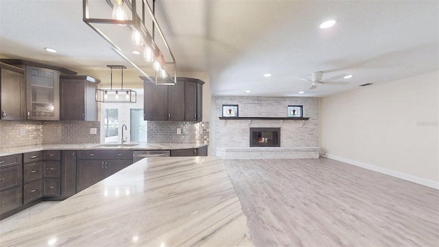 4121 SW 6th Ave, Ocala, FL 34471 - kitchen with dark brown cabinets, tasteful backsplash, light stone counters, recessed lighting, and a ceiling fan