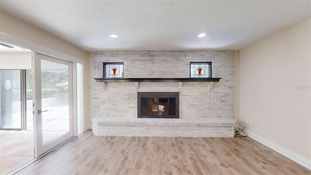 4121 SW 6th Ave, Ocala, FL 34471 - unfurnished living room with wood finished floors, a brick fireplace, and recessed lighting