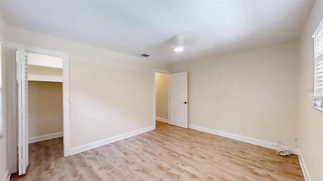 4121 SW 6th Ave, Ocala, FL 34471 - unfurnished bedroom with light wood finished floors and a walk in closet