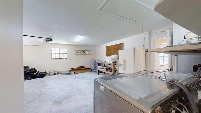 4121 SW 6th Ave, Ocala, FL 34471 - garage with white refrigerator with ice dispenser, washer / dryer, and a garage door opener