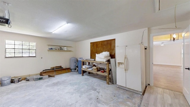 4121 SW 6th Ave, Ocala, FL 34471 - garage featuring white refrigerator with ice dispenser and a garage door opener