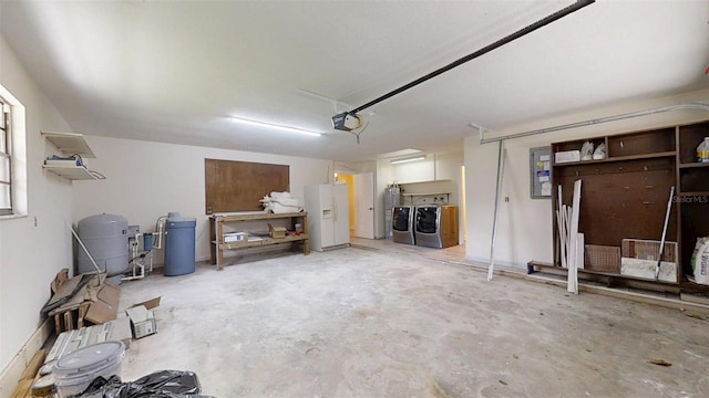4121 SW 6th Ave, Ocala, FL 34471 - garage featuring washing machine and dryer, a garage door opener, white fridge with ice dispenser, and water heater