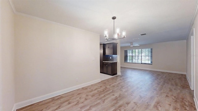 4121 SW 6th Ave, Ocala, FL 34471 - unfurnished dining area with light wood finished floors, a chandelier, and crown molding