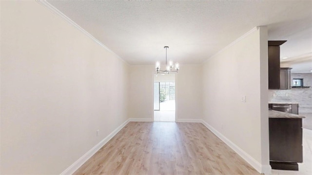 4121 SW 6th Ave, Ocala, FL 34471 - unfurnished dining area with ornamental molding, light wood finished floors, and a chandelier