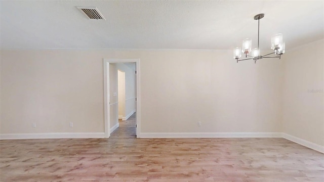 4121 SW 6th Ave, Ocala, FL 34471 - empty room with a chandelier and light wood finished floors