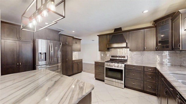 4121 SW 6th Ave, Ocala, FL 34471 - kitchen with appliances with stainless steel finishes, dark brown cabinets, light stone counters, backsplash, and recessed lighting