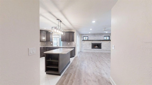 4121 SW 6th Ave, Ocala, FL 34471 - kitchen with open shelves, a ceiling fan, light wood-style flooring, a center island, and recessed lighting