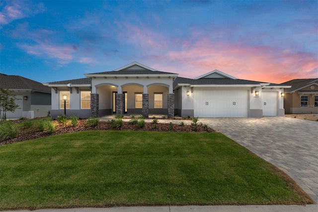 10032 SW 85th Place Rd, Ocala, FL 34481 - view of front facade with stucco siding, an attached garage, a front yard, and decorative driveway