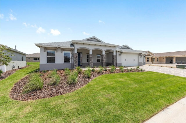 10032 SW 85th Place Rd, Ocala, FL 34481 - view of front of property featuring decorative driveway, an attached garage, a front yard, and stucco siding