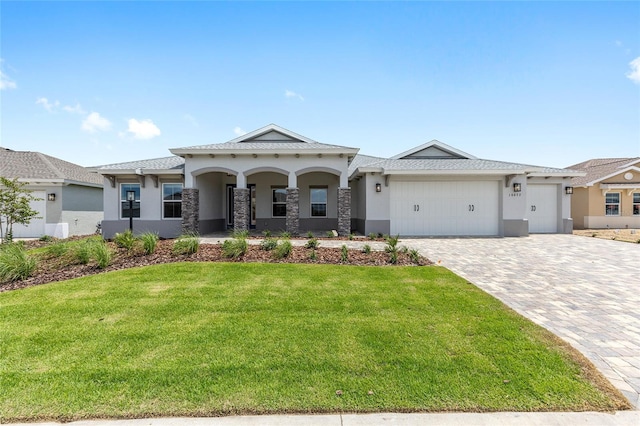 10032 SW 85th Place Rd, Ocala, FL 34481 - view of front of property featuring stucco siding, a front yard, an attached garage, decorative driveway, and a porch