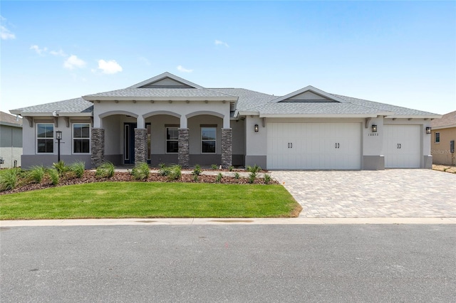 10032 SW 85th Place Rd, Ocala, FL 34481 - view of front of house with a front lawn, an attached garage, driveway, and stucco siding