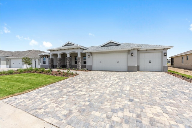 10032 SW 85th Place Rd, Ocala, FL 34481 - view of front facade with stucco siding, decorative driveway, a front yard, and an attached garage