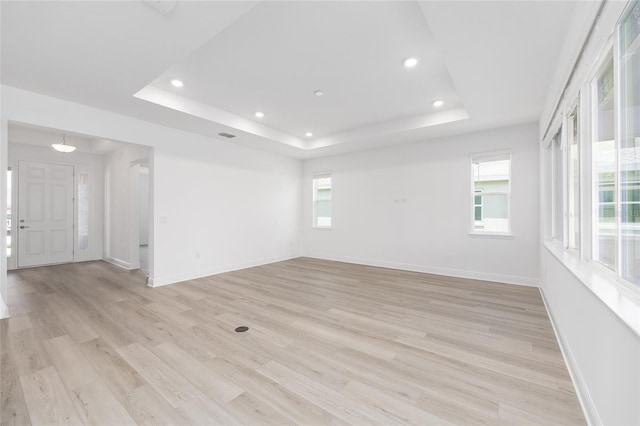 10032 SW 85th Place Rd, Ocala, FL 34481 - unfurnished room with a tray ceiling, recessed lighting, and light wood-type flooring