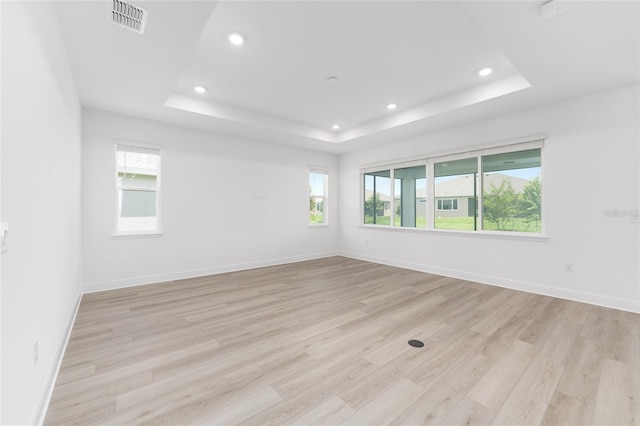 10032 SW 85th Place Rd, Ocala, FL 34481 - unfurnished room with a tray ceiling, recessed lighting, and light wood-style floors