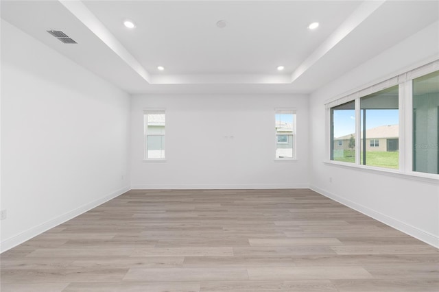 10032 SW 85th Place Rd, Ocala, FL 34481 - unfurnished room with plenty of natural light, a raised ceiling, recessed lighting, and light wood-style floors
