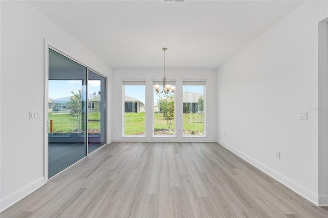 10032 SW 85th Place Rd, Ocala, FL 34481 - empty room with a chandelier and light wood finished floors