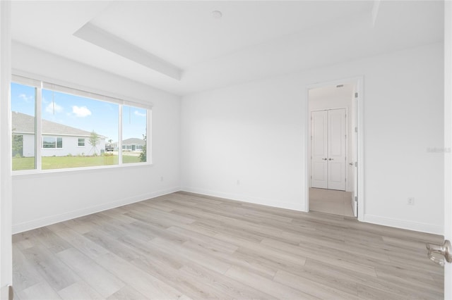10032 SW 85th Place Rd, Ocala, FL 34481 - empty room with light wood-style floors and a raised ceiling