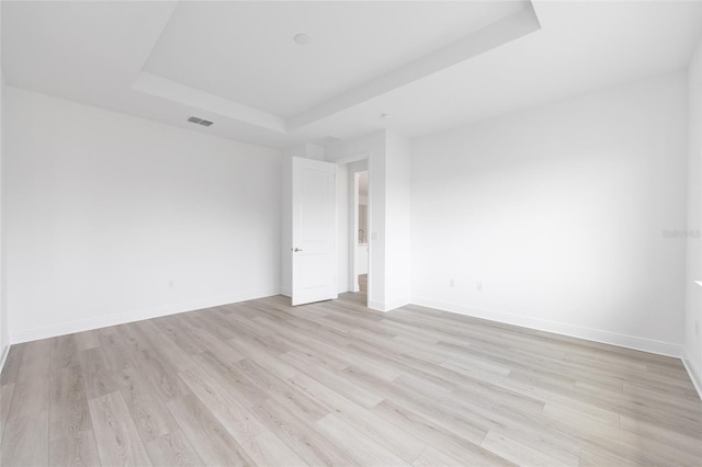 10032 SW 85th Place Rd, Ocala, FL 34481 - unfurnished room with a raised ceiling and light wood-style flooring