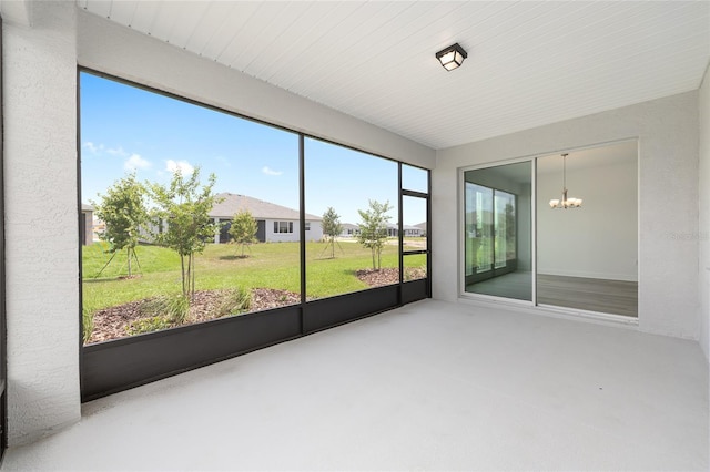10032 SW 85th Place Rd, Ocala, FL 34481 - unfurnished sunroom with a chandelier and concrete floors