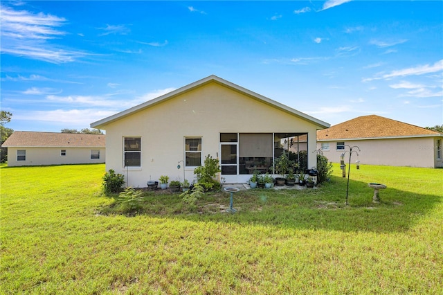 1824 W Zoe Ct, Lecanto, FL 34461 - back of property featuring a sunroom, a yard, and stucco siding