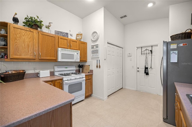 1824 W Zoe Ct, Lecanto, FL 34461 - kitchen featuring white appliances, brown cabinets, open shelves, backsplash, and light countertops