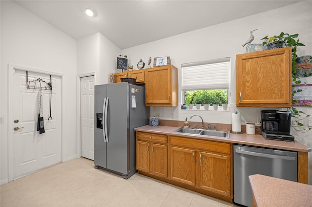 1824 W Zoe Ct, Lecanto, FL 34461 - kitchen featuring appliances with stainless steel finishes, light countertops, brown cabinetry, and lofted ceiling