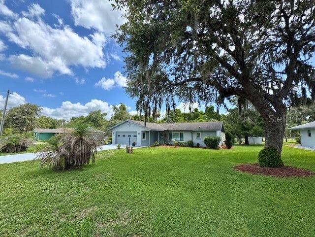916 Jones Ave, Inverness, FL 34453 - view of front of house with an attached garage, a front lawn, and concrete driveway
