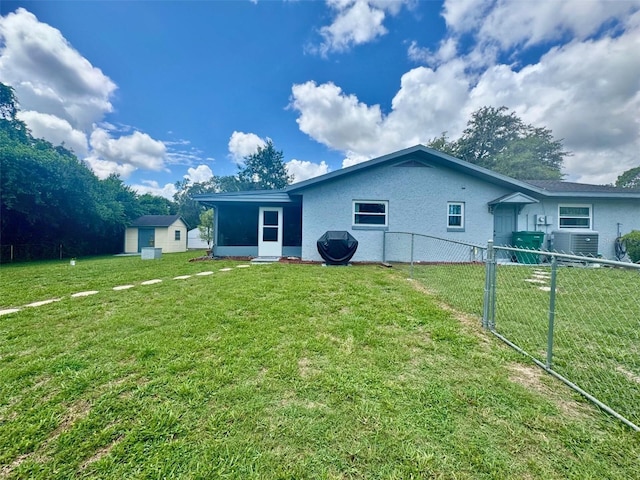 916 Jones Ave, Inverness, FL 34453 - back of house with stucco siding and a storage unit