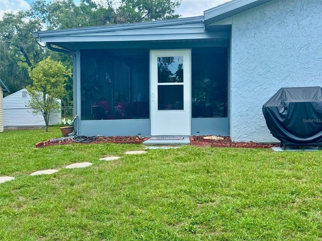 916 Jones Ave, Inverness, FL 34453 - view of exterior entry featuring stucco siding and a lawn