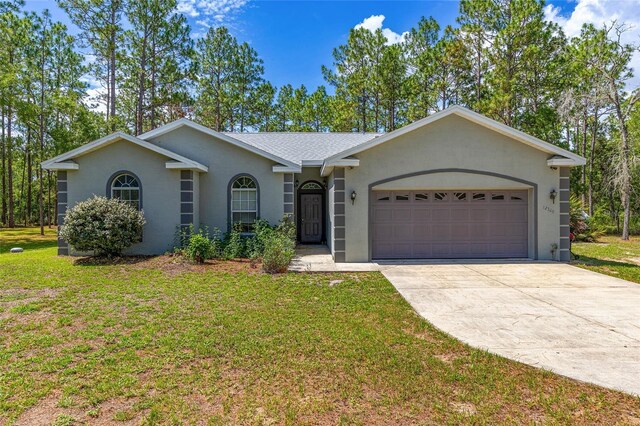 12320 SW 62nd Pl, Ocala, FL 34481 - ranch-style house with a garage, concrete driveway, a front yard, and stucco siding