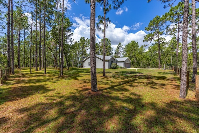 12320 SW 62nd Pl, Ocala, FL 34481 - view of green lawn featuring an attached garage