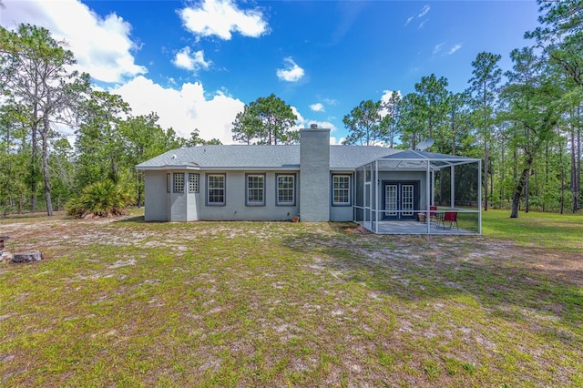 12320 SW 62nd Pl, Ocala, FL 34481 - back of house with a patio, a chimney, glass enclosure, and a yard