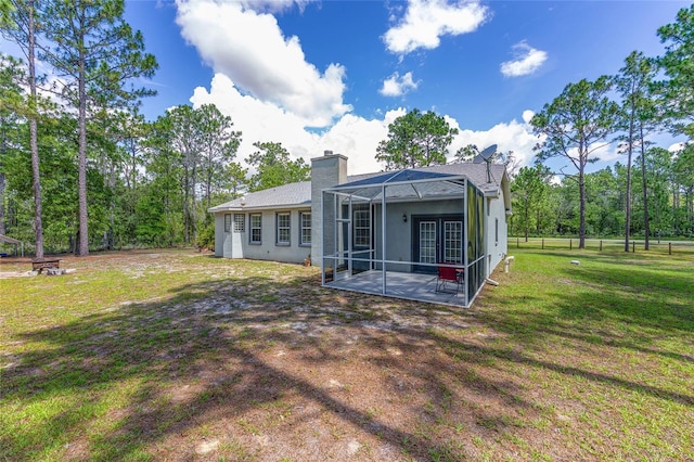 12320 SW 62nd Pl, Ocala, FL 34481 - rear view of property with a patio, a yard, a lanai, a chimney, and french doors