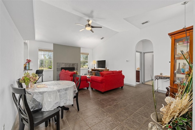 12320 SW 62nd Pl, Ocala, FL 34481 - dining space featuring ceiling fan, arched walkways, a tile fireplace, and vaulted ceiling