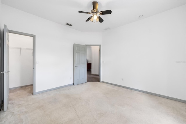 12320 SW 62nd Pl, Ocala, FL 34481 - unfurnished bedroom with light colored carpet, a spacious closet, a closet, and a ceiling fan