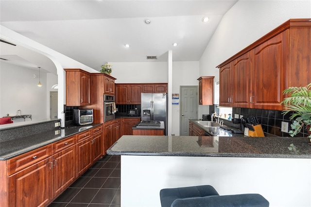 12320 SW 62nd Pl, Ocala, FL 34481 - kitchen featuring stainless steel appliances, a peninsula, backsplash, dark tile patterned floors, and recessed lighting