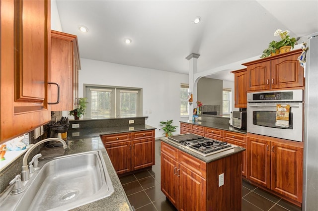 12320 SW 62nd Pl, Ocala, FL 34481 - kitchen with stainless steel appliances, dark countertops, a kitchen island, a peninsula, and recessed lighting