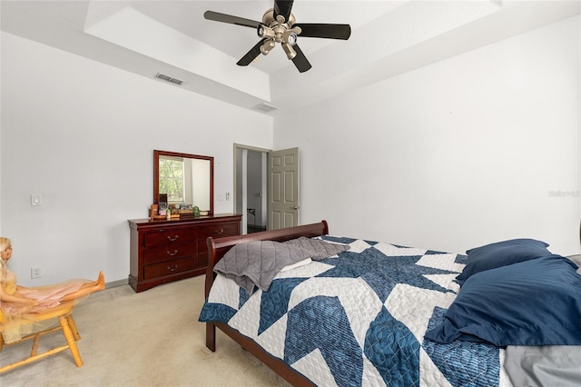 12320 SW 62nd Pl, Ocala, FL 34481 - bedroom with light colored carpet, a raised ceiling, and ceiling fan