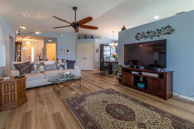 1768 SW 156th Ln, Ocala, FL 34473 - living room featuring a chandelier, a ceiling fan, wood finished floors, lofted ceiling, and arched walkways