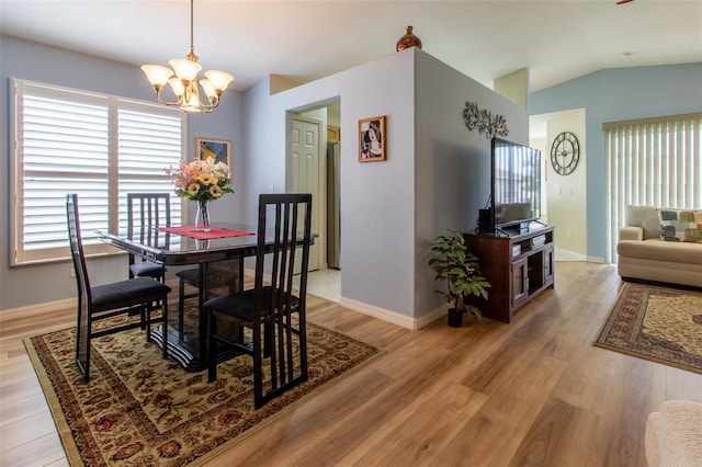 1768 SW 156th Ln, Ocala, FL 34473 - dining room with a chandelier, lofted ceiling, and light wood-style flooring