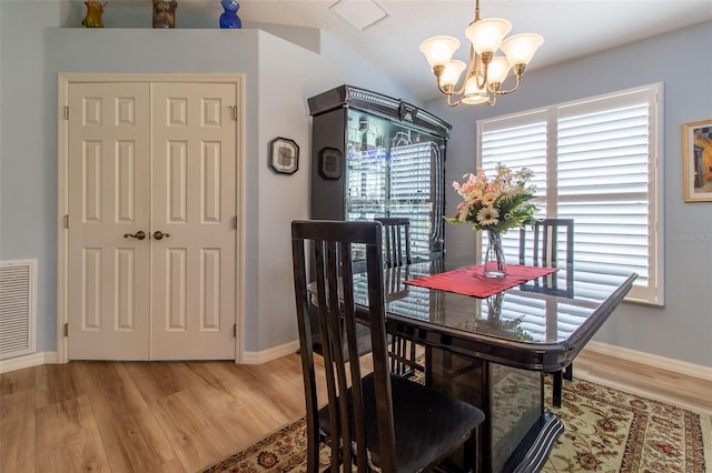 1768 SW 156th Ln, Ocala, FL 34473 - dining area with a chandelier, light wood-style floors, and lofted ceiling